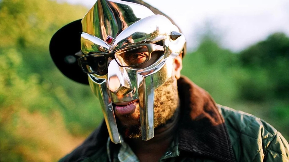 Photo of the late MF Doom wearing his mask 